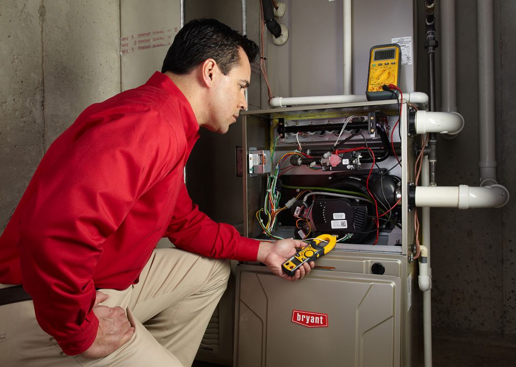 HVAC technician repairing an indoor furnace in Midvale