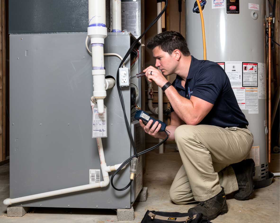 HVAC technician performing a furnace tune-up in Midvale