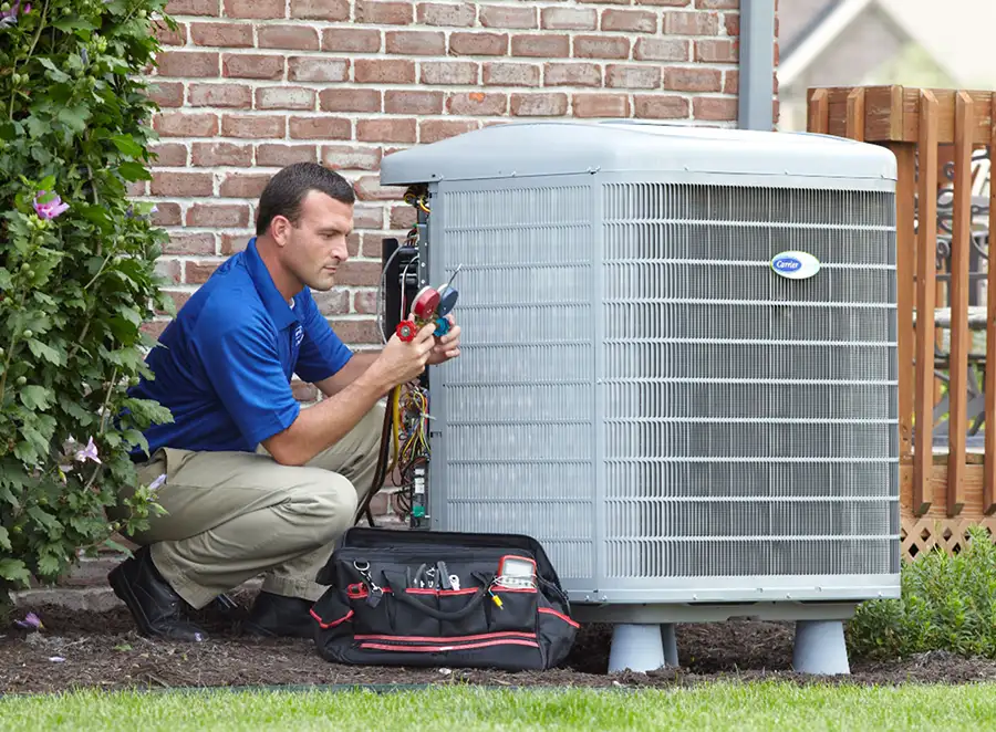 HVAC technician inspecting an outdoor air conditioning unit in Midvale