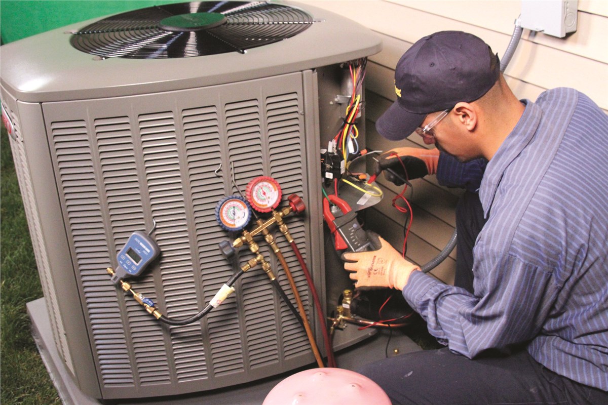 HVAC technician testing an outdoor air conditioning unit in Midvale