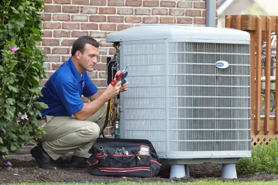 design-air-heating-and-air-conditioning-decatur-il-05 – Copy HVAC technician inspecting an outdoor air conditioning unit in Midvale, UT